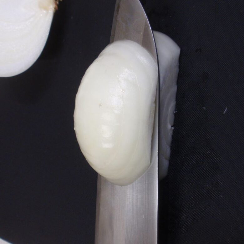 玉ねぎのみじん切りの作り方　３　半分に切った切り口と水平に細かく包丁で切れ込みを入れます。